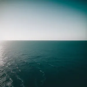 Serenity at Sunset: Tropical Beach Waves Under Golden Sky