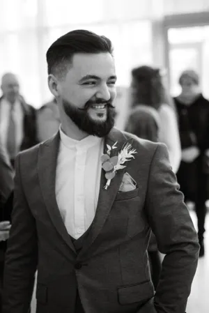 Confident businessman in black suit with beard