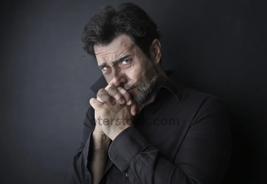 Picture of Confident businessman playing harmonica in office.