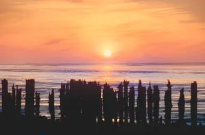 Orange Sunset Silhouette Over Ocean Pier