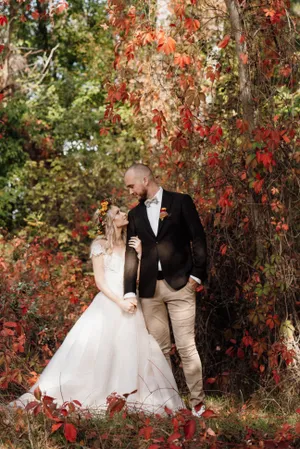 Happy Wedding Couple in Park Embracing Outdoors