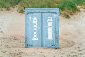 Container architecture against sky with wall and bin.