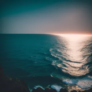 Serene Tropical Sunset Over Sparkling Ocean Waves