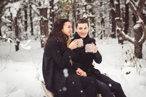 Happy mother and son smiling in snowy park