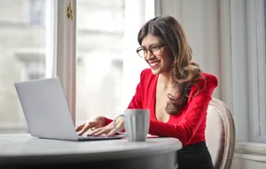 Smiling businesswoman working on laptop at home office