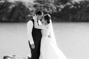 Happy newlywed couple celebrating love on wedding day outdoors.