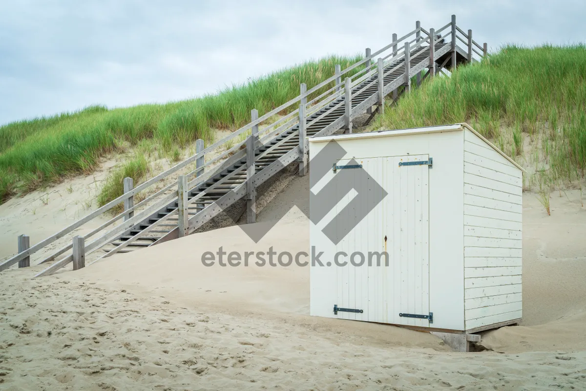 Picture of Ocean coast landscape view with water and railing.