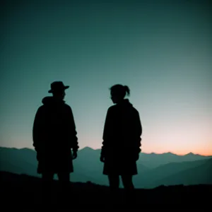 Silhouette of Man at Sunset with Spectators