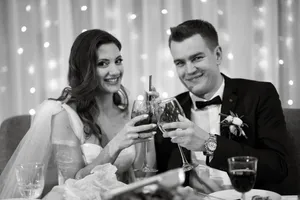 Happy groom celebrating with friends by drinking beer.