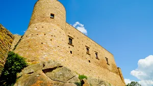 Medieval stone fortress against a blue sky.