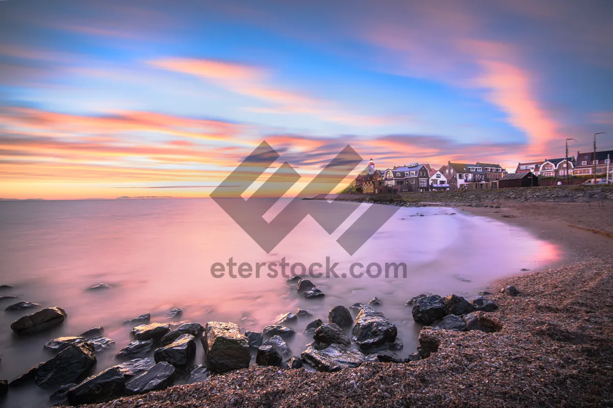 Picture of Tropical sunset silhouette over peaceful ocean waves