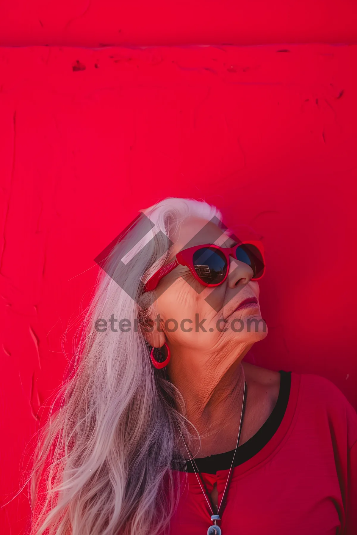 Picture of Attractive female model with sunglasses smiling in studio