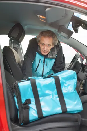 Happy man driving a car with seat belt