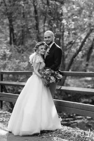 Joyful wedding couple surrounded by flowers and love