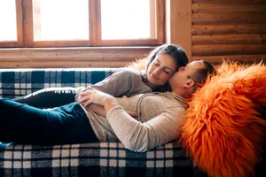 Happy family relaxing on convertible sofa at home