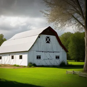 Rustic country barn nestled in the grassy countryside