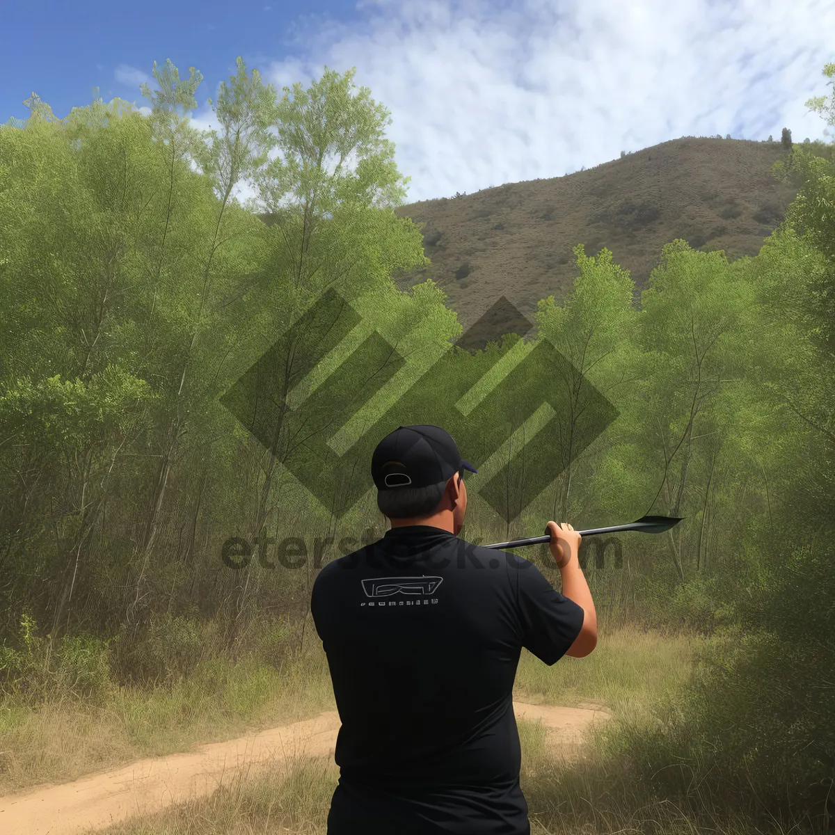 Picture of Golfer taking a swing on the grassy course