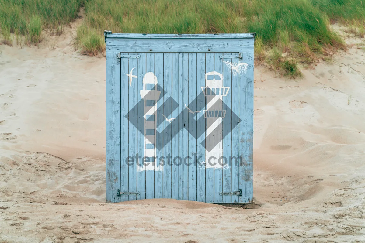 Picture of Container architecture against sky with wall and bin.