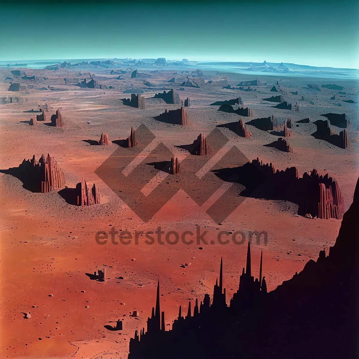 Picture of Sunset over sandy beach and rocky landscape.