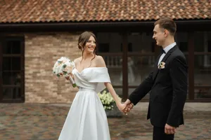 Happy Wedding Couple Smiling with Flowers Bouquet