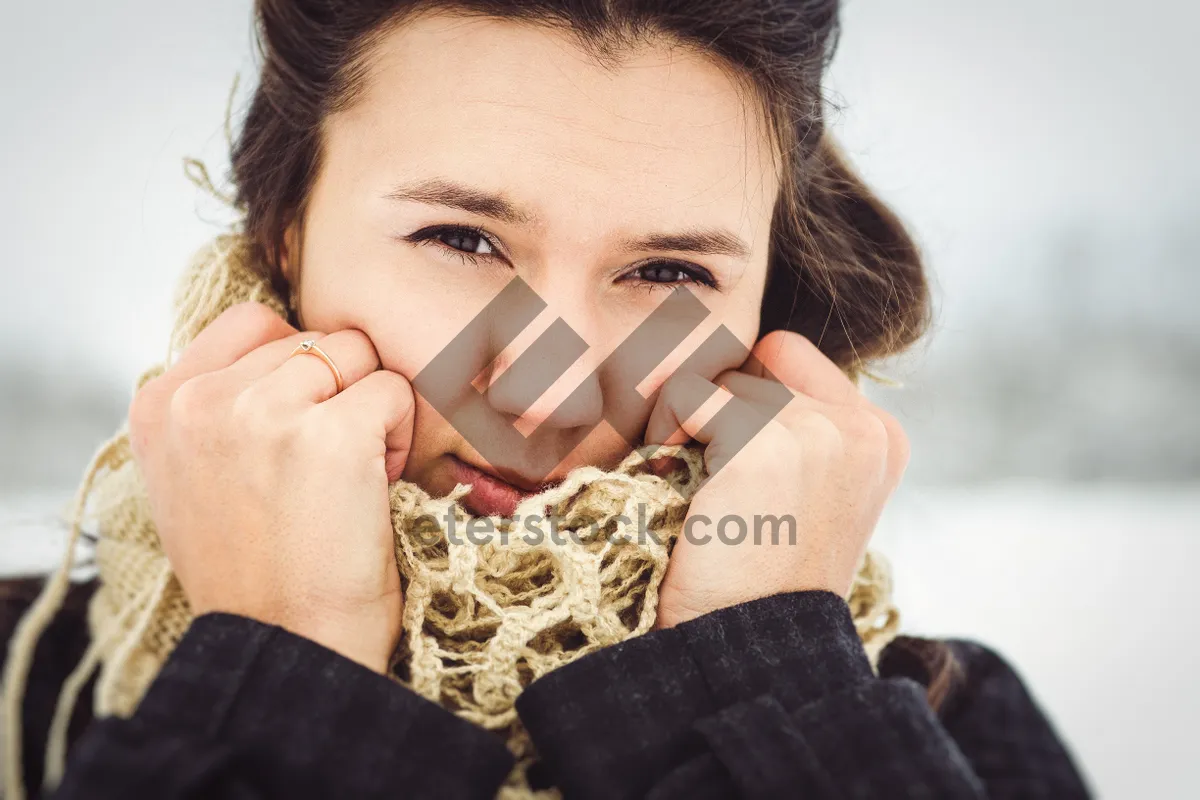 Picture of Attractive brunette fashion model smiling with burrito on face.