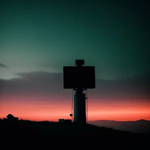 Silhouette Birdhouse against Majestic Sunset Sky