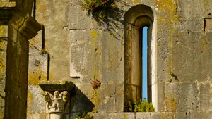 Medieval church window with ancient stone arch