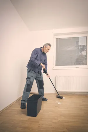 Male golfer cleaning golf club with swab.