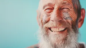 Happy elderly man smiling in portrait.