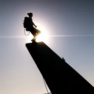 Skateboarding Silhouette Against Sunset Sky