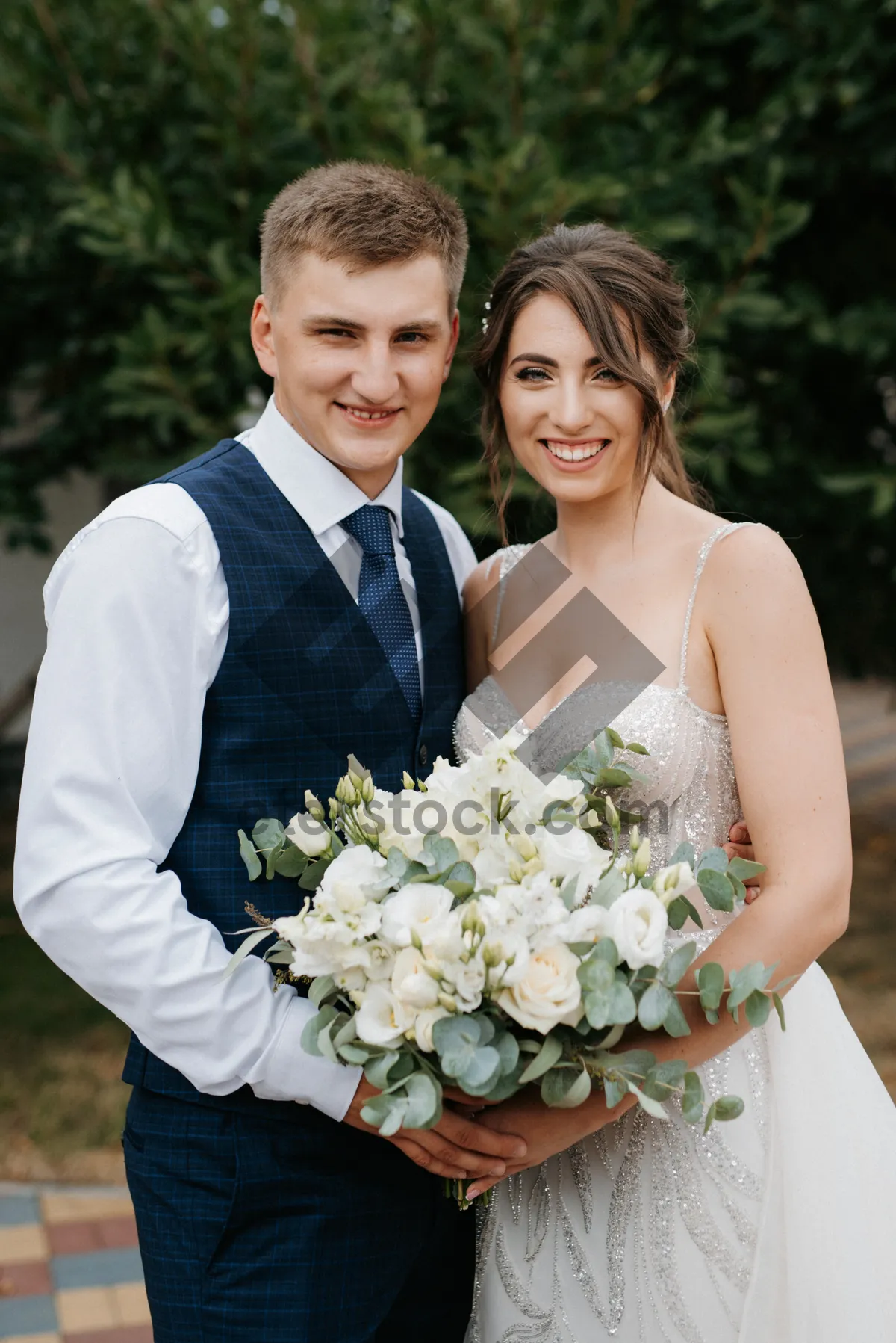 Picture of Happy Bride and Groom at Wedding Celebration Smiling Outdoors