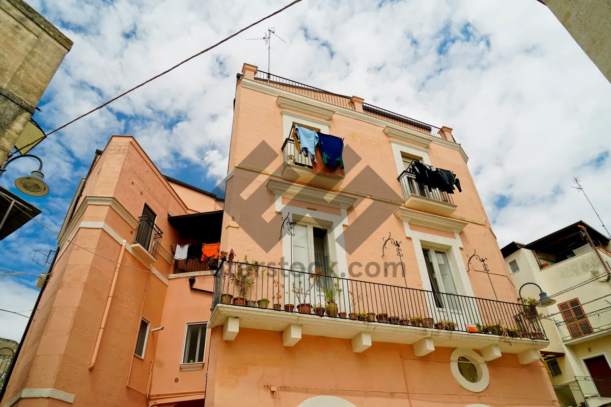 Picture of Old city building with balcony in town.