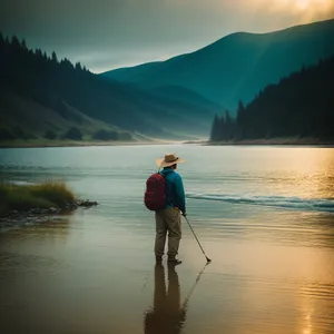 Serene sunset over a lakeside with a fisherman