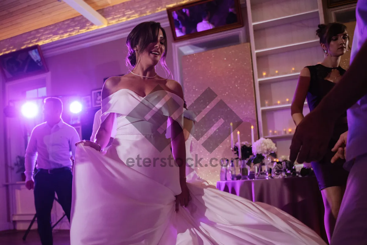 Picture of Happy bride in beautiful wedding gown holding bouquet.