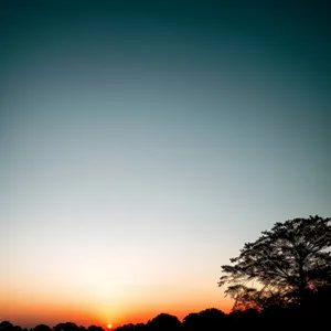 Vibrant Sunset Sky Over Rolling Landscape