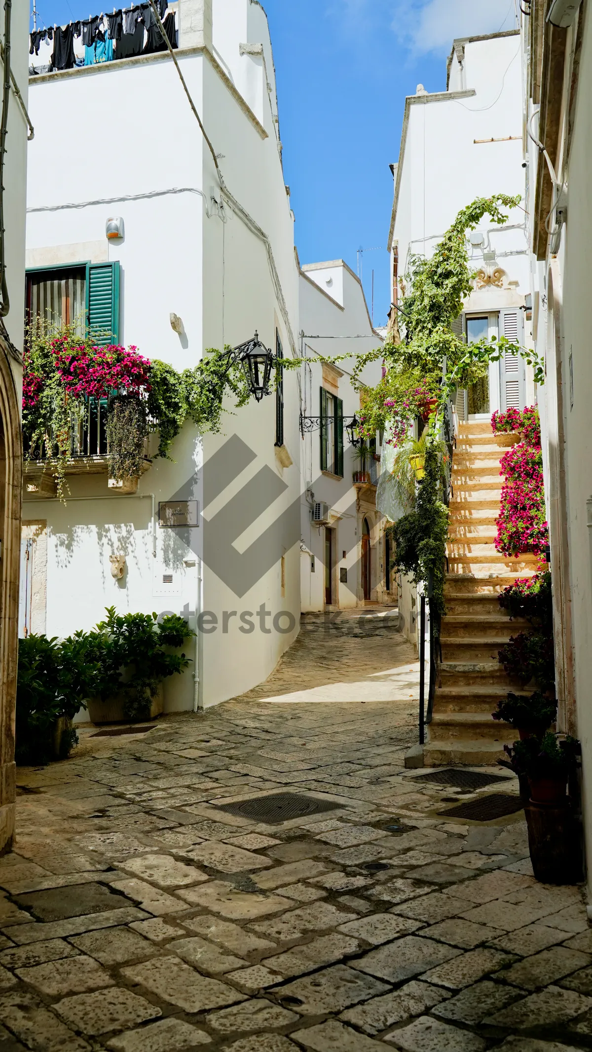 Picture of Old stone house in city with flowered patio