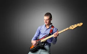 Rock musician playing electric guitar on stage concert.