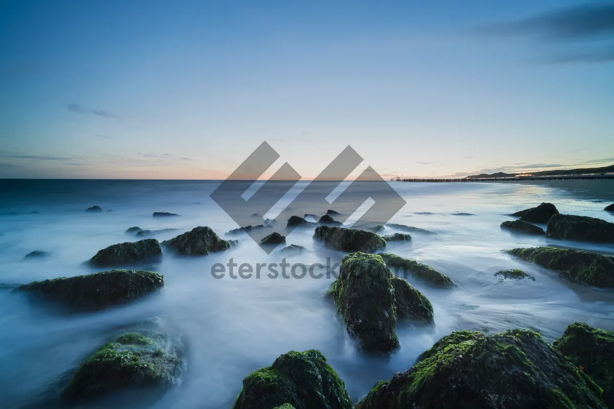 Picture of Tropical beach with sun and waves crashing.