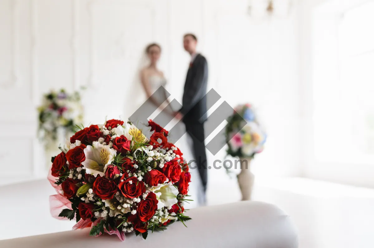 Picture of Happy couple celebrating wedding surrounded by beautiful flowers