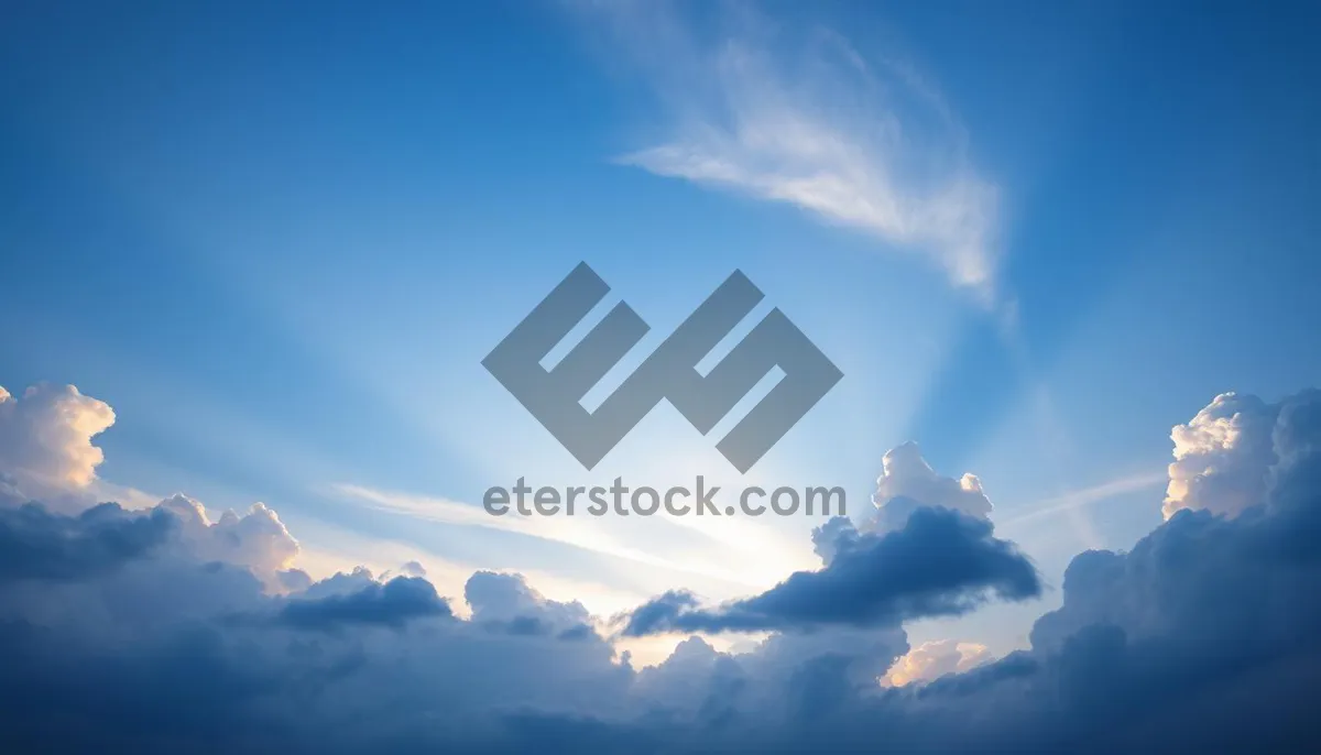 Picture of Sunny sky with fluffy clouds in summer landscape.