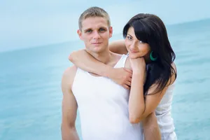 Attractive couple smiling on a beach vacation