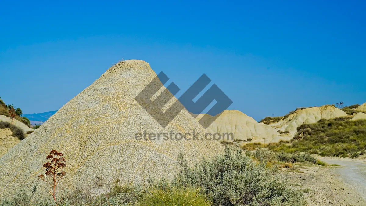 Picture of Ancient Pyramid in Desert Landscape at Sunset