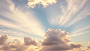 Summer sky with fluffy clouds and bright sunlight.