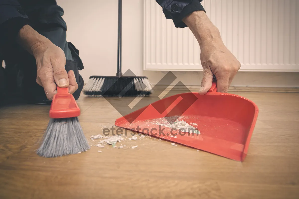 Picture of Person cleaning ottoman with broom and pad