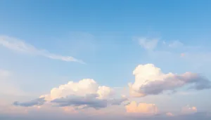 Sunlit summer sky with fluffy clouds