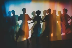 Silhouette of businessman presenting at patriotic nighttime stadium event