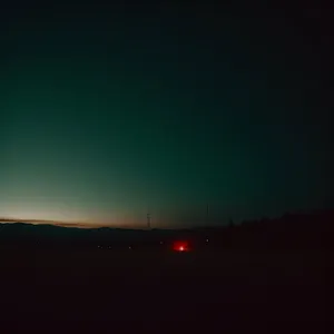 Golden Horizon: Captivating Sunset Sky and Mountain Silhouette