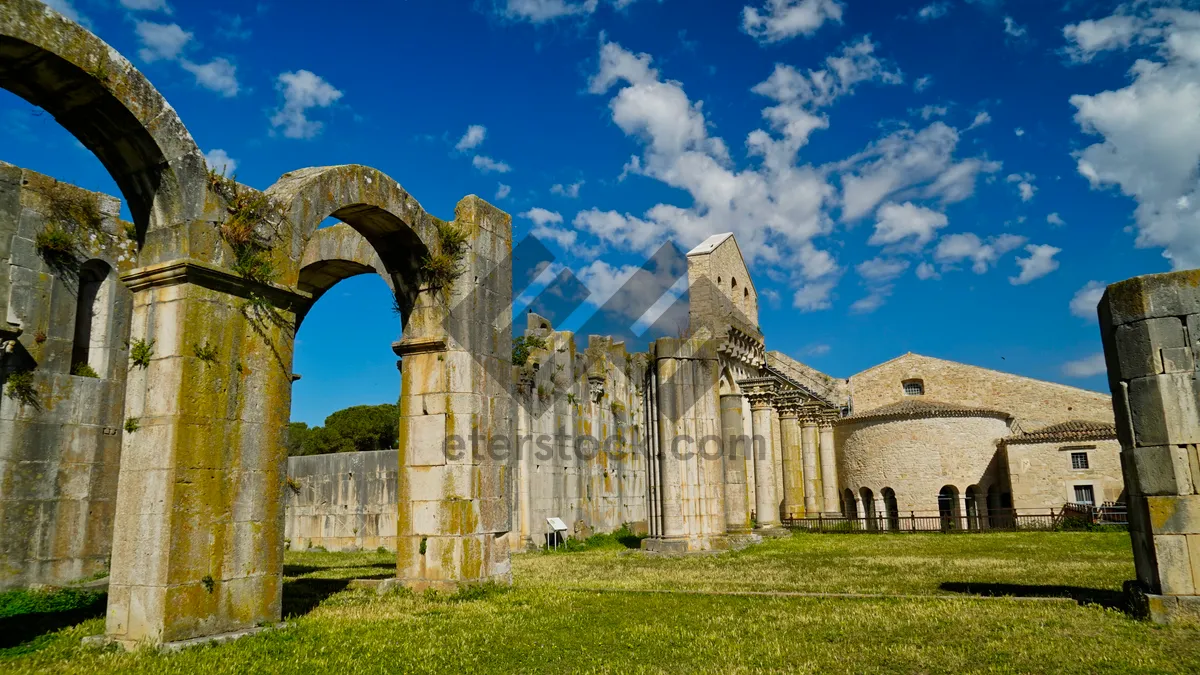 Picture of Ancient Stone Cathedral Tower in Historic City Skyline.