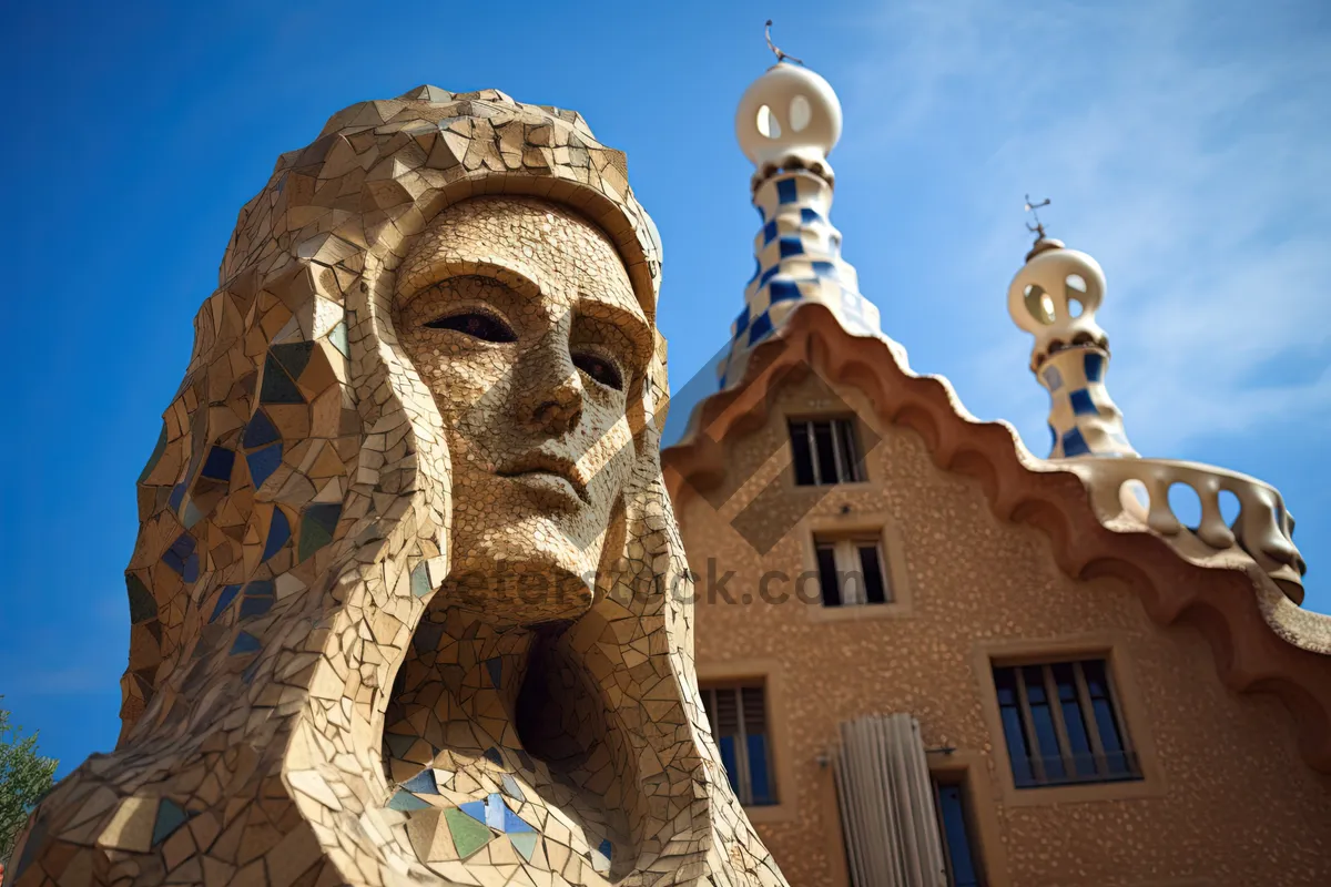 Picture of Historic Cathedral Tower with Golden Cross on Brick Facade.