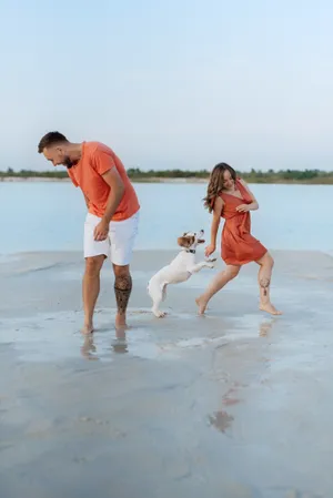 Happy family walking on the beach under the summer sky